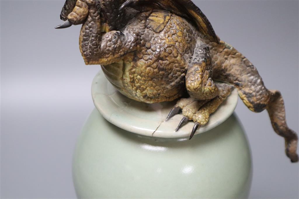 A Chinese celadon vase and cover having later cold-painted metal dragon terminal (repair)